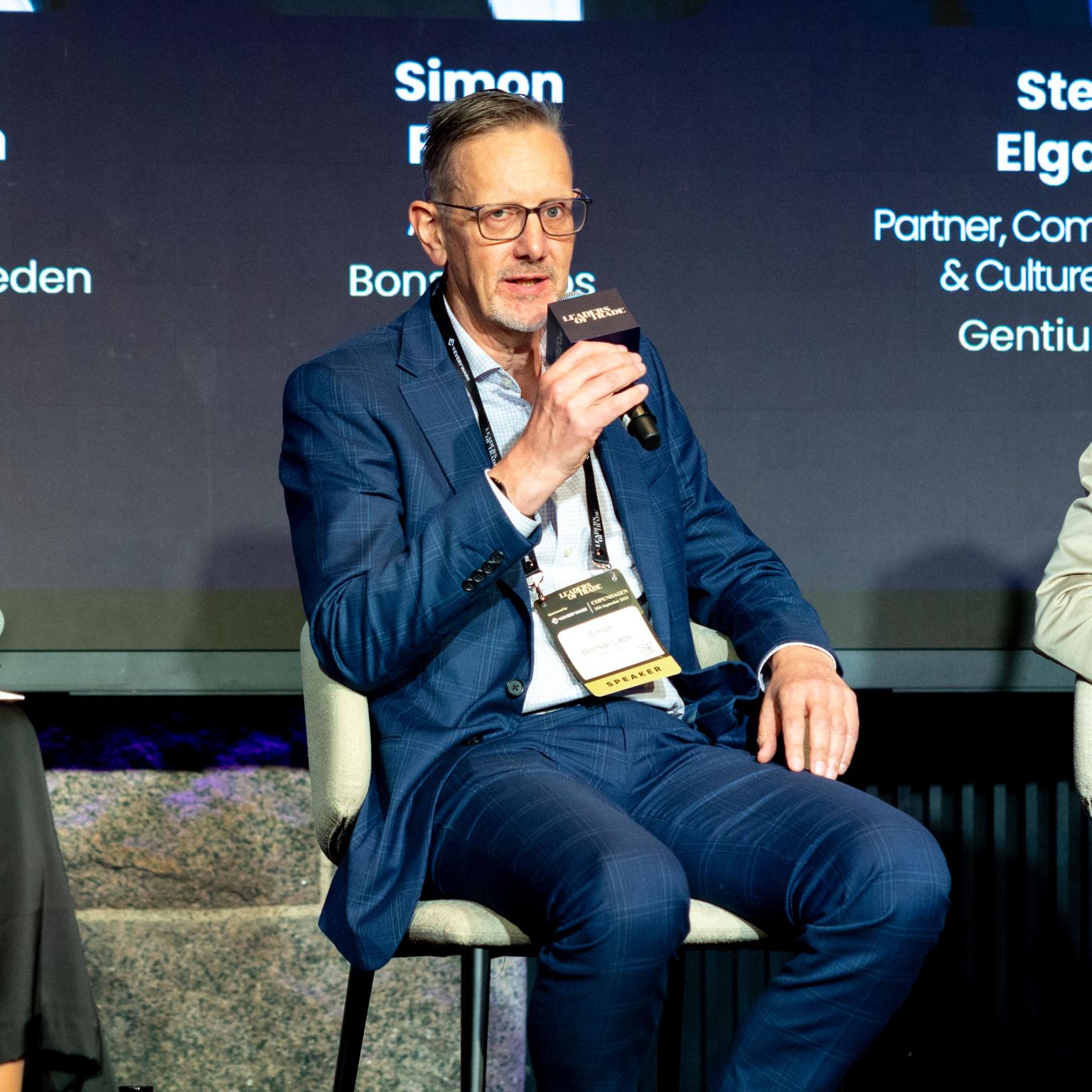 Simon Poole speaking on stage at Leaders of Trade, Copenhagen